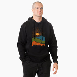 Man wearing a black hoodie with a colorful mountain design on a white background