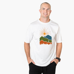 Man wearing a white t-shirt with a colorful mountain design on a white background