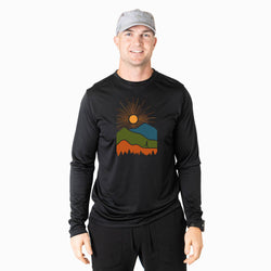 Man wearing a black long-sleeve shirt with a colorful mountain design on a white background