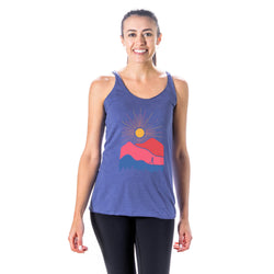 Woman wearing a blue tank top with a mountain design on a white background