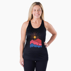 Woman wearing a black tank top with a colorful mountain design on a white background