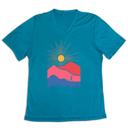 Blue t-shirt with a colorful mountain and sun design on a white background