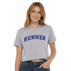 Woman wearing a gray t-shirt with 'RUNNER' printed in blue on a white background