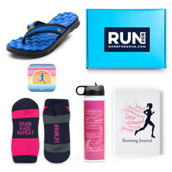 Collection of running-themed items including sandals, socks, water bottle, and journal with a 'RUN' box in the background.