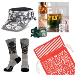 Image of a trail runner gift set that includes a camouflage visor, socks, a cocktail glass & sticker with a red gift bag.