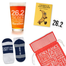 Collection of marathon-themed items including a glass, socks, a greeting card, sticker, and a red gift bag on a white background.