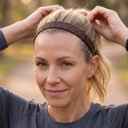 Person adjusting a glittered headband  outdoors