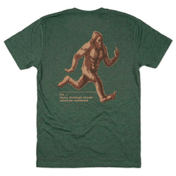 Green t-shirt with a graphic of a running creature on the back, displayed against a white background.