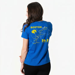 Woman wearing a blue t-shirt with a map of Boston and marathon details on the back.