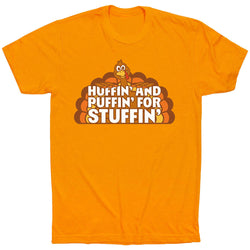 An orange short-sleeve crewneck t-shirt featuring a cartoon turkey graphic and the text 'HUFFIN' AND PUFFIN' FOR STUFFIN'' printed on the chest, displayed against a solid white background.