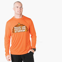 A man wearing an orange long-sleeve performance t-shirt with a cartoon turkey graphic and the text 'HUFFIN AND PUFFIN FOR STUFFIN'.