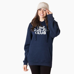A woman wearing a navy blue pullover hoodie with 'The Daily Run Club' printed in white across the chest, paired with a beige baseball cap and black leggings, against a plain white background.