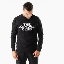 A man wearing a black crewneck sweatshirt with 'THE Daily Run CLUB' printed in white across the chest, photographed against a clean white background.