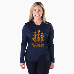 A woman modeling a navy blue long-sleeve V-neck athletic shirt with an orange graphic of three witches and the text 'RUNNING WITH MY WITCHES' on the front, set against a plain white background.