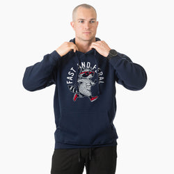 A man wearing a navy blue hoodie with white printed text that reads 'FAST AND FERAL'.