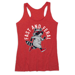 A heather red racerback tank top featuring a graphic of a raccoon running in the center, wearing a gray hoodie and red sneakers, with the text 'FAST AND FERAL' arched above it.