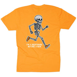 An orange short-sleeve t-shirt shown flat against a white background, featuring a graphic of a running skeleton with the text 'I'M A NIGHTMARE BEFORE A RUN' printed below it.