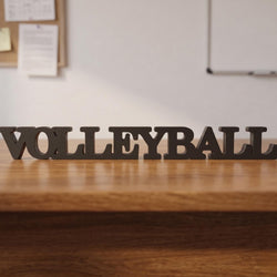 Wooden letters spelling 'VOLLEYBALL' on a wooden surface with a light background.