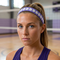 Woman wearing a purple volleyball headband and tank top in an indoor sports facility.