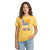 Person wearing a yellow t-shirt with colorful volleyball text on a white background