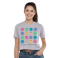 Woman wearing a gray t-shirt with colorful volleyball and smiley face designs on a white background
