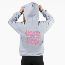 A person shown from the back wearing a light heather gray hoodie with a pink and orange graphic on the back that reads 'HARD WORK BEATS TALENT WHEN TALENT DOESN'T WORK HARD' surrounded by stars and volleyballs. The person is holding the hood up with both hands against a plain white background.