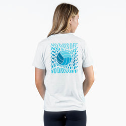 A woman viewed from behind wearing a white short-sleeve T-shirt with a large blue volleyball graphic and the text 'NO DAYS OFF' repeated across the back.
