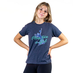A woman modeling a heather navy blue t-shirt with a graphic that reads 'Play like a Girl' in teal and blue. She is posing with her hands on her hips against a solid white background.