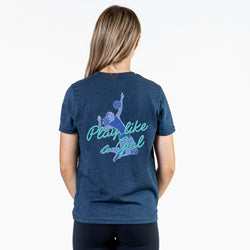 A woman viewed from the back wearing a heather navy blue t-shirt with a graphic of a volleyball player and the text 'Play like a Girl' in light blue and teal, set against a plain white background.