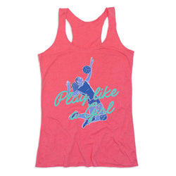 A coral pink racerback tank top featuring a blue graphic of a volleyball player and the text 'Play like a Girl' in teal script, displayed against a solid white background.