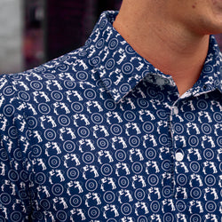 Navy blue wrestling polo shirt featuring a repeating white wrestler silhouette and mat print pattern.