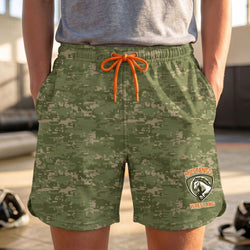 Green camouflage shorts with orange drawstring and Mustangs Wrestling logo worn by a person.