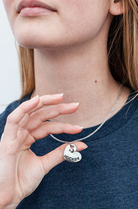 Female Wearing Hockey Heart Silver Necklace